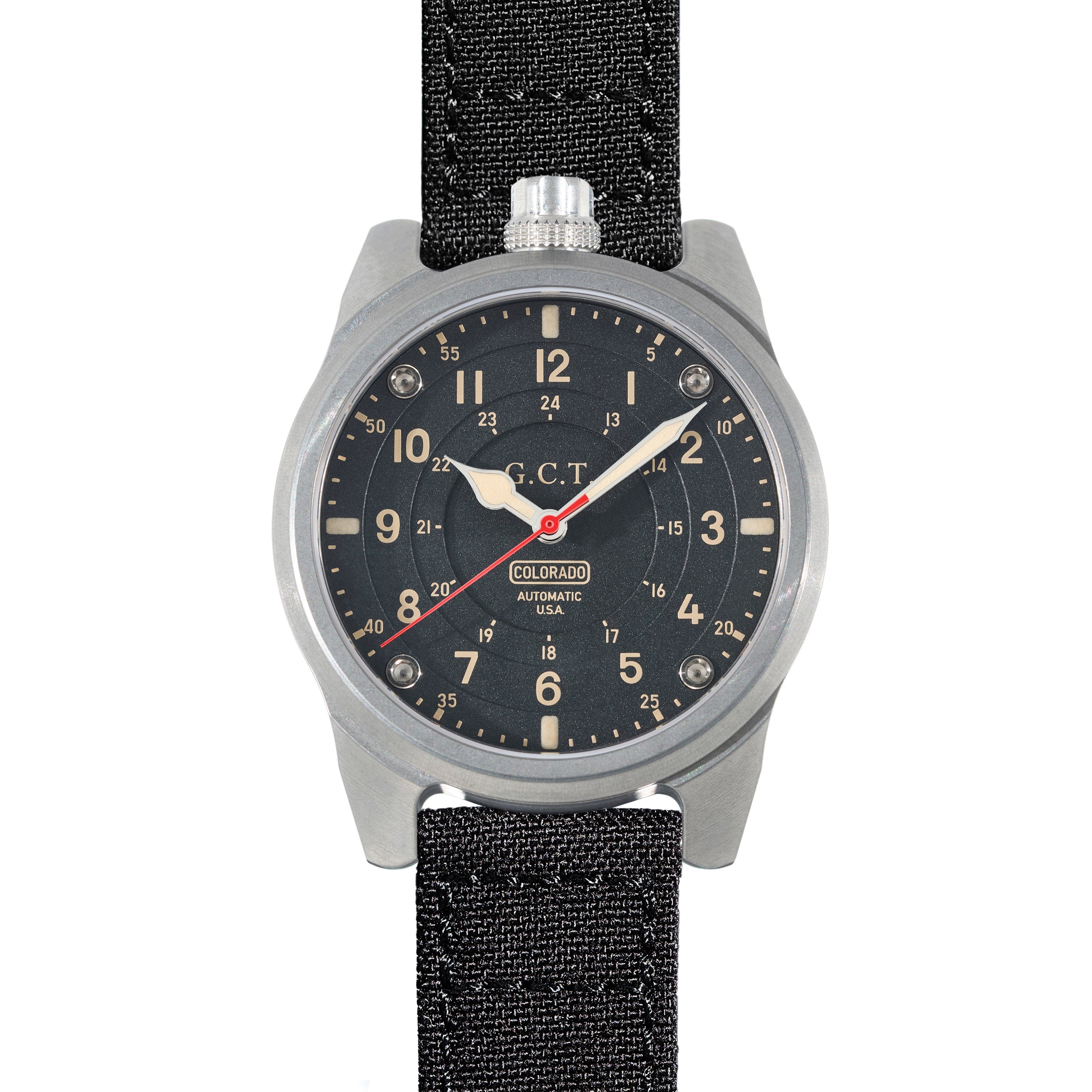 This image features The GCT - Steel Case - Matte Dial watch, showcasing its sleek and functional design. The watch has a matte black dial marked with light-colored numerals and details, set within a durable steel case.